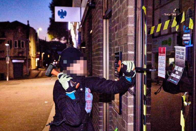 Woman arrested on suspicion of criminal damage to bank’s door