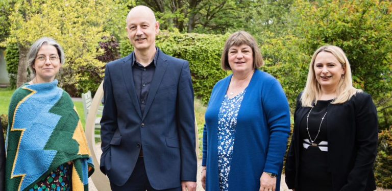 Leaders walk over hot coals for hospice